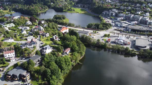 Aerial view Nesttun with bybanen light rail and modern buildings in between small freshwater lakes -