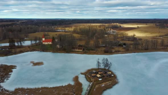 Araisi Lake Castle in Latvia Aerial Shot From Above. Historical Wooden Buildings on Small Island in