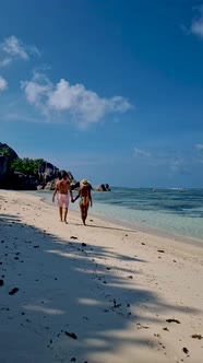 Anse Source d'Argent La Digue Seychelles Young Couple Men and Woman on a Tropical Beach During a