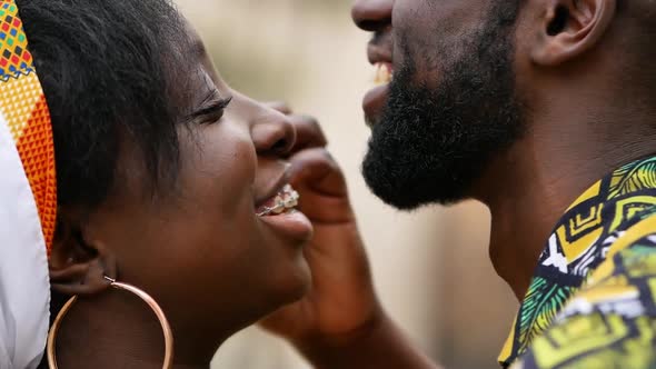 Happy ethnic couple embracing on city street