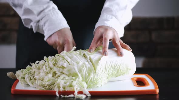 The Chef Is Cutting a Cauliflower on a Cutting Board