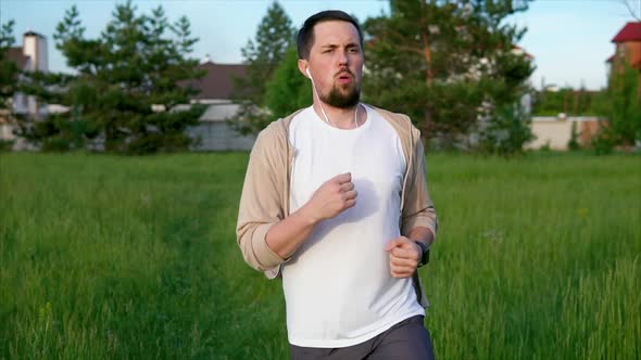 Jogging in the Morning. Male Runner in Sportswear Doing Morning Jogging