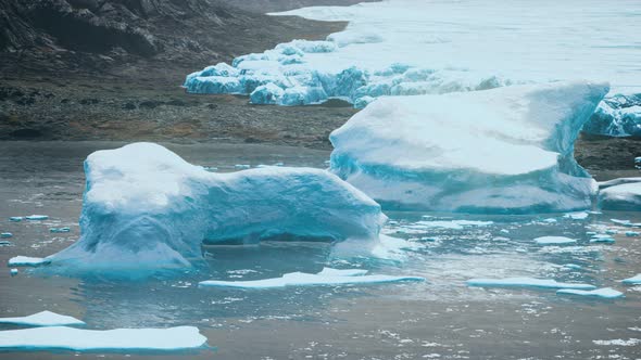 Antarctic Icebergs Near Rocky Beach