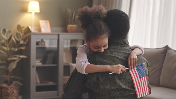 Little Girl Embracing Military Father Returning Home alt