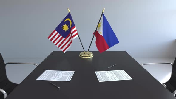 Flags of Malaysia and the Philippines on the Table
