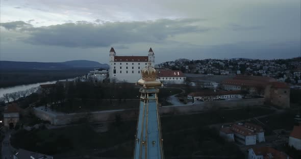Medium shot of Crown on St. Martin Church in Bratislava at twilight with Castle in background, Aeria
