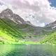 Fast moving clouds over a turquoise alpine lake - VideoHive Item for Sale
