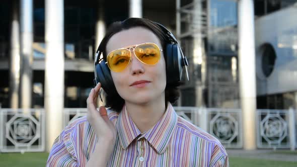 Young Girl Portrait in Headphones Listens to Music