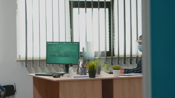 Paralysed Financial Worker Working with Protection Mask