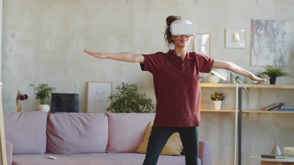 Young Woman in VR Headset Exercising at Home