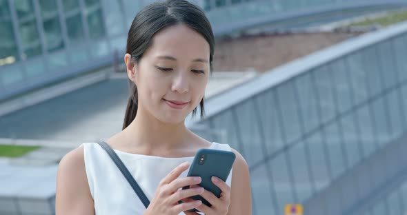 Woman check on cellphone at the station