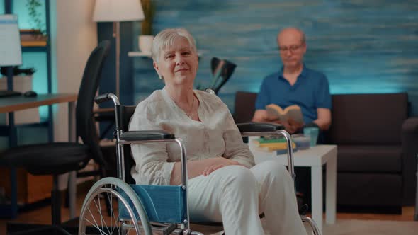 Portrait of Retired Woman Sitting in Wheelchair at Home