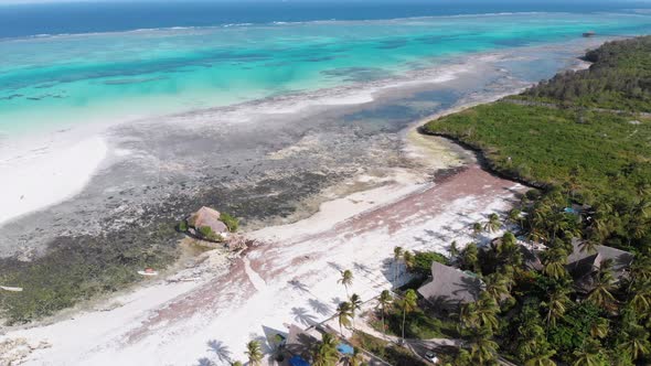 The Rock Restaurant in Ocean Built on Cliff at Low Tide on Zanzibar Aerial View