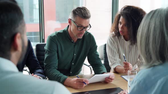 Businessman Signing Contract at Group Meeting Handshaking Business Partner