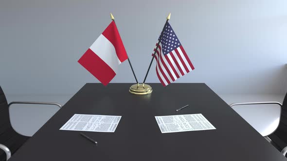 Flags of Peru and the United States and Papers on the Table alt