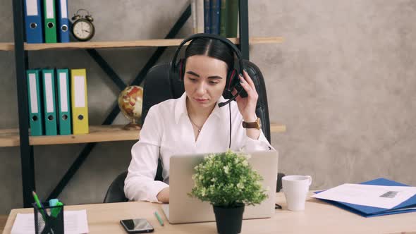 Female Call Center Worker Answers Customer Call in Office