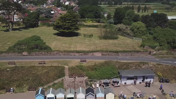 Aerial STATIC CROP, Pull Back from a rural town out past the beach over the ocean