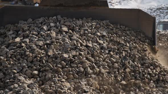 Bulldozer Moving Pile of Stones at Construction Site of Oil Refinery in Winter Season.