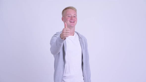 Happy Young Blonde Handsome Man Pointing at Camera