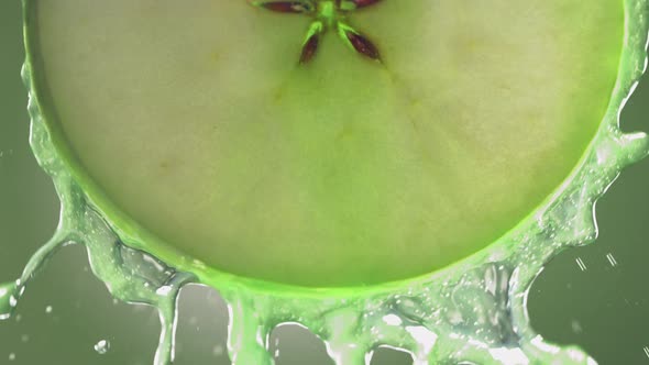 Flowing Green Apple Juice From Apple Slice  Macro Shot in Slow Motion