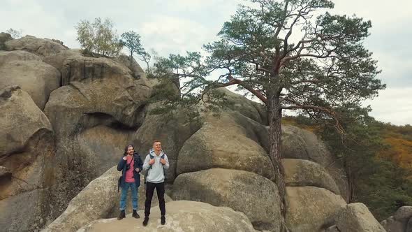 Happy Backpackers on Rocks