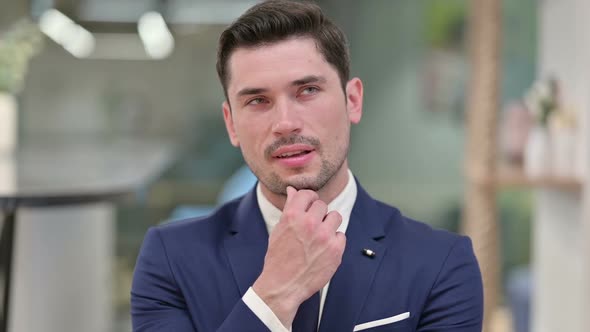 Pensive Young Businessman Thinking About Something