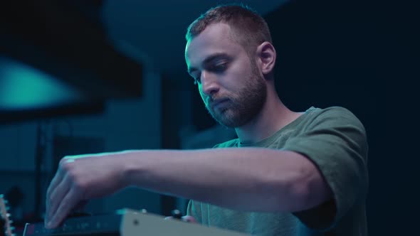 Music production studio. Producer. Man working in the recording studio with computer and mixer