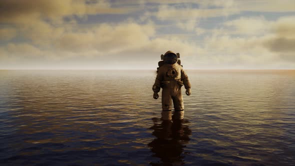 Spaceman in the Sea Under Clouds at Sunset