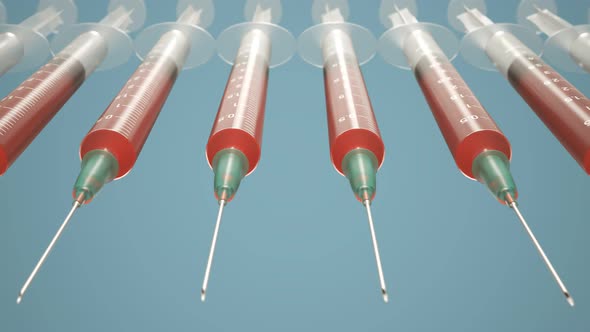 Row of plastic disposable syringes filled with red liquid or blood. Loopable.