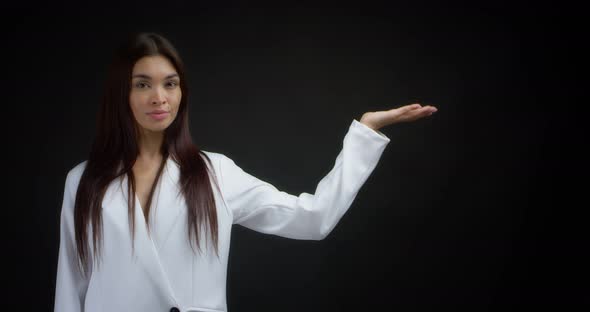 Woman Pointing to an Empty Space for your Advertising Content