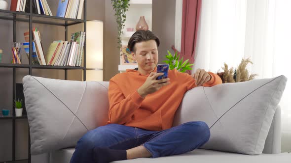 Young man sitting on the sofa.