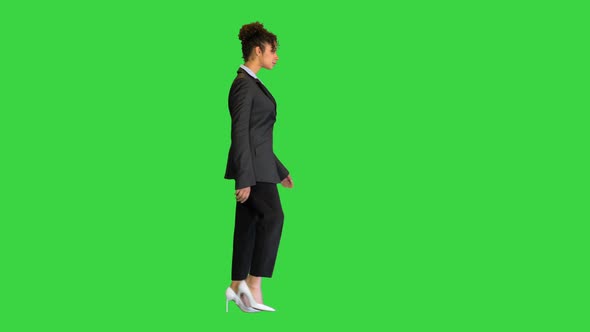 Young African American Businesswoman Walking on a Green Screen Chroma Key