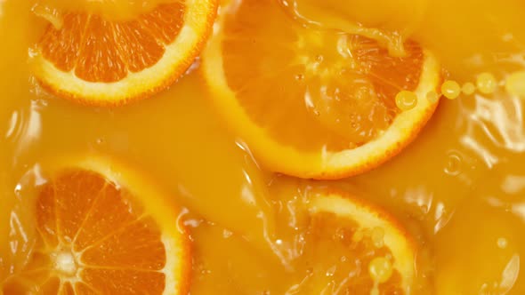 Super Slow Motion Shot of Orange Slices Splashing To Orange Juice at 1000Fps.