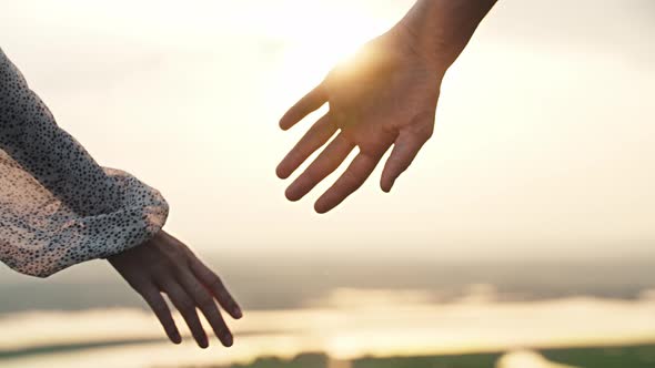 Cute Couple of Man and Woman Taking Each Other By the Hand on Sunset