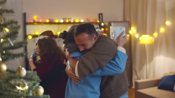 Grandparents Visiting Children and Grandchildren and Giving Christmas Present