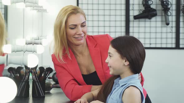 Happy Beautiful Woman Applying Makeup on Her Cute Daughter