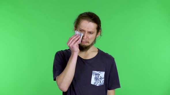 A Portrait of a Man Holding Money in His Hands and Wiping His Tears with It Then Throwing the Money