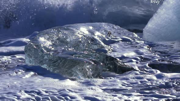 Ice From a Glacier Washing By Atlantic Ocean Waves on a Black Diamond Beach in Iceland