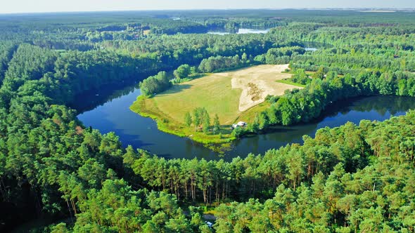 Aerial view of winding river and green forests in summer