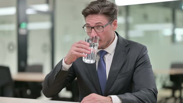 Thirsty Middle Aged Businessman Drinking Water 