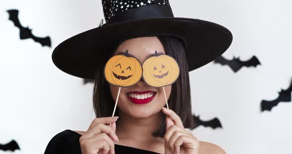 Halloween Party, Young Asian Witch Posing with Pumpkin Photo Props, Close Up Portrait