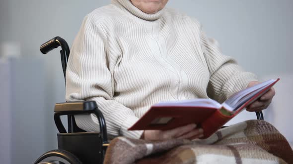 Depressed Woman in Wheelchair Watching Photos, Missing Family, Loneliness