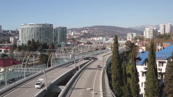 Car Moving on Asphalt Highway on Urban Architecture Landscape Mountain in Distance