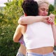 Two multiethnic young women outdoors hugging meeting after long time - VideoHive Item for Sale