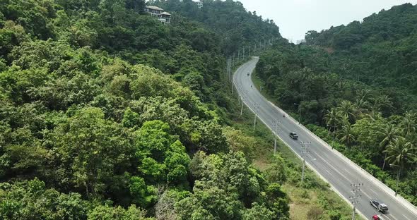 Flying over Highway with Cars and Motorbikes in Tropical Country