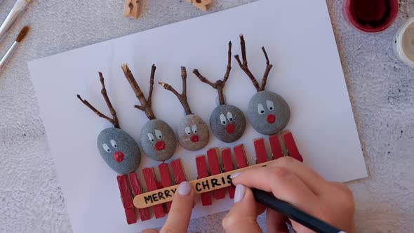 Making Diy Merry Christmas Deer on Greeting Card Postcard Made of Pebbles Sea Stones Clothespins and