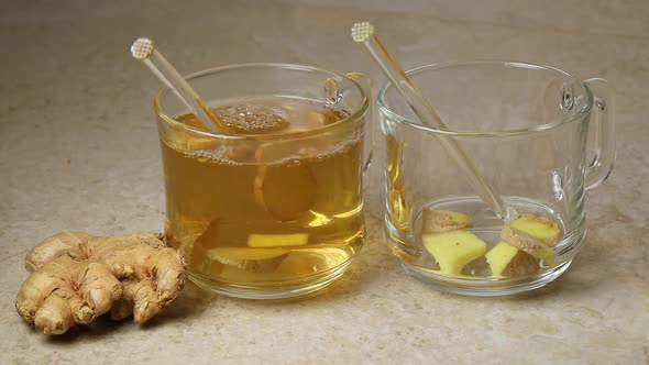Pouring fresh hot ginger tea and ginger root 