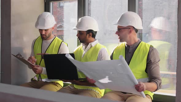 Male Architects in Helmets with Laptop at Office