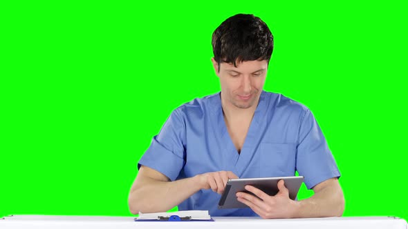 Doctor Uses a Tablet and Shows Thumb. Green Screen