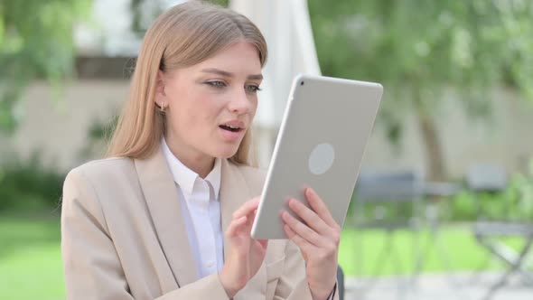 Outdoor Young Businesswoman Celebrating on Tablet